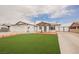 The home has a well-manicured front lawn, brick-paved driveway, and attached garage at 902 Westminster Ave, Las Vegas, NV 89119
