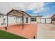Charming home featuring a brick-paved yard with a covered area and white fence at 902 Westminster Ave, Las Vegas, NV 89119