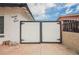 White driveway gate with decorative black hardware, set against a blue sky at 902 Westminster Ave, Las Vegas, NV 89119