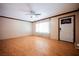Bright living room featuring hardwood floors, a ceiling fan, and a large window at 902 Westminster Ave, Las Vegas, NV 89119
