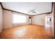 Spacious living room features wood floors, a ceiling fan and large windows providing lots of natural light at 902 Westminster Ave, Las Vegas, NV 89119