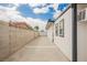 Spacious side yard featuring a block wall, partial fence, and direct access to the backyard area at 902 Westminster Ave, Las Vegas, NV 89119