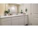 Bathroom with white cabinets, countertop, and large mirror, creating a clean and bright space at 9338 Soothing Sea St # Lot 90, Las Vegas, NV 89178
