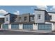 Modern townhome garages with stylish blue doors and contemporary exterior lighting at 9338 Soothing Sea St # Lot 90, Las Vegas, NV 89178