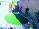 The backyard features drought-tolerant landscaping, gravel, plants, and a putting green at 95 Palm Park Ct, Las Vegas, NV 89183