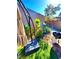 Backyard with patio, built in grill, and mature landscaping at 95 Palm Park Ct, Las Vegas, NV 89183