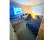 Modern bedroom setup with a TV, a work desk, a cozy bed, and simple decor elements at 95 Palm Park Ct, Las Vegas, NV 89183