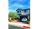 Beautiful two-story house with a manicured lawn, a driveway, and a serene neighborhood setting at 95 Palm Park Ct, Las Vegas, NV 89183