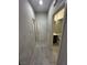 Hallway view featuring a doorway to the bathroom with stylish tile flooring at 95 Palm Park Ct, Las Vegas, NV 89183