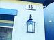Close-up of the house number and a decorative lantern on the exterior wall at 95 Palm Park Ct, Las Vegas, NV 89183