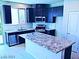 Modern kitchen with stainless steel appliances, granite countertops, and island with breakfast bar at 95 Palm Park Ct, Las Vegas, NV 89183