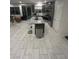 Open concept kitchen with island, stainless steel appliances, and tile flooring at 95 Palm Park Ct, Las Vegas, NV 89183