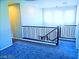 Spacious loft area with multiple windows for natural light and dark wood railings at 95 Palm Park Ct, Las Vegas, NV 89183