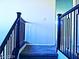 A carpeted stair landing with modern dark wood railing at 95 Palm Park Ct, Las Vegas, NV 89183
