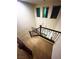 Elegant staircase with carpeted steps, dark wood railings, and contemporary lighting features at 95 Palm Park Ct, Las Vegas, NV 89183