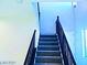 Carpeted stairway with dark wood railing leading to the upper level of the home at 95 Palm Park Ct, Las Vegas, NV 89183