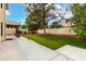 Expansive backyard with lush lawn, mature tree, patio, and privacy fence, ideal for outdoor living at 9604 Windom Point Ave, Las Vegas, NV 89129