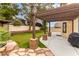 Covered patio and pergola create an inviting outdoor space with lush landscaping at 9604 Windom Point Ave, Las Vegas, NV 89129