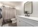 Bathroom showcasing new faucet and fixtures, shower with neutral curtain, and mirror above sink at 9604 Windom Point Ave, Las Vegas, NV 89129