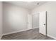 A bedroom with gray trim, wood look floors, and a doorway at 9604 Windom Point Ave, Las Vegas, NV 89129