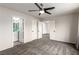 Carpeted bedroom featuring a ceiling fan and multiple doors at 9604 Windom Point Ave, Las Vegas, NV 89129