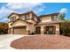Charming two-story home featuring a well-manicured yard and inviting front porch at 9604 Windom Point Ave, Las Vegas, NV 89129