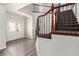 Inviting foyer showcases a wood and iron staircase, white walls, and wood-look floors at 9604 Windom Point Ave, Las Vegas, NV 89129