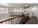 Bright upstairs hallway with wood and iron railing, carpet, and storage at 9604 Windom Point Ave, Las Vegas, NV 89129