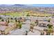 Aerial view of the neighborhood with a baseball field, green space, and beautiful mountain views in the background at 961 Wembly Hills Pl, Henderson, NV 89011