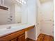 Well-lit bathroom featuring a vanity with a sink, storage, and a shower over bath at 961 Wembly Hills Pl, Henderson, NV 89011