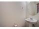 Bathroom featuring a sink with chrome fixtures, a round mirror, and a bright window at 961 Wembly Hills Pl, Henderson, NV 89011