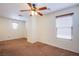 Well-lit carpeted bedroom featuring a ceiling fan and large windows for natural light at 961 Wembly Hills Pl, Henderson, NV 89011
