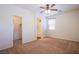 Comfortable bedroom showcasing a ceiling fan, plush carpet, and a walk-in closet at 961 Wembly Hills Pl, Henderson, NV 89011