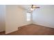 Bright bedroom features neutral walls, plush carpet, and a ceiling fan at 961 Wembly Hills Pl, Henderson, NV 89011
