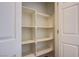 A walk-in closet with multiple shelves and rod, illuminated by a ceiling light at 961 Wembly Hills Pl, Henderson, NV 89011