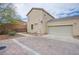 Exterior view showing a driveway, garage, and landscaping features at 961 Wembly Hills Pl, Henderson, NV 89011
