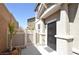 A close up of a home's front entrance with a security door and small courtyard with planter at 961 Wembly Hills Pl, Henderson, NV 89011