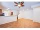 Open living area with tile flooring, ceiling fan, and kitchen with breakfast bar at 961 Wembly Hills Pl, Henderson, NV 89011