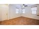 Spacious living room featuring tile flooring, ceiling fan, and multiple windows at 961 Wembly Hills Pl, Henderson, NV 89011