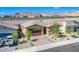 Wide aerial shot of a cozy home showcasing desert landscaping and views of nearby mountains at 10281 Sequoia Falls Pl, Las Vegas, NV 89149