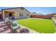 Spacious backyard featuring artificial turf, a fenced perimeter, and an outdoor table at 10281 Sequoia Falls Pl, Las Vegas, NV 89149