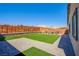 Large backyard featuring artificial turf, a wood fence, and outdoor seating at 10281 Sequoia Falls Pl, Las Vegas, NV 89149