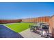 Backyard with artificial grass and a wood fence at 10281 Sequoia Falls Pl, Las Vegas, NV 89149
