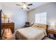 Comfortable bedroom with a ceiling fan and natural light, creating a warm and inviting space at 10281 Sequoia Falls Pl, Las Vegas, NV 89149