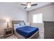 Cozy bedroom with plush carpet, a ceiling fan, and a bright window at 10281 Sequoia Falls Pl, Las Vegas, NV 89149