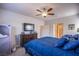 Spacious bedroom with large dresser, TV, and ceiling fan at 10281 Sequoia Falls Pl, Las Vegas, NV 89149