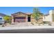 Attractive single-Gathering home showcasing desert landscaping, a brick driveway, and welcoming entrance at 10281 Sequoia Falls Pl, Las Vegas, NV 89149