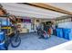 Spacious garage with overhead door, motorcycle, work bench, and plenty of storage at 10281 Sequoia Falls Pl, Las Vegas, NV 89149