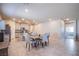 Open floor plan featuring a kitchen with an island, dining area, and tile flooring throughout at 10281 Sequoia Falls Pl, Las Vegas, NV 89149