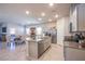 Bright, open-concept kitchen with stainless appliances, center island, and adjacent dining area at 10281 Sequoia Falls Pl, Las Vegas, NV 89149